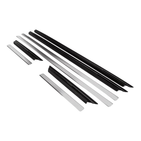 Several long, narrow black and silver metallic strips are arranged parallel to each other on a white background.