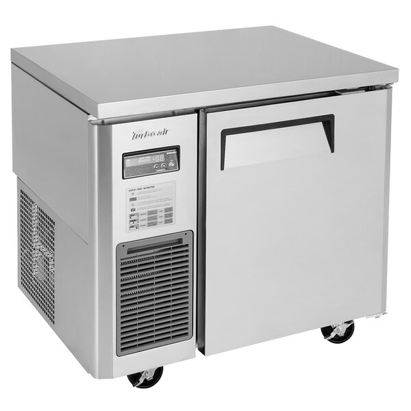 A silver Turbo Air undercounter refrigerator with a solid door.
