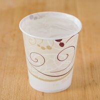 Wax-coated paper cup holding water