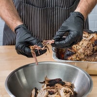 Food prepping meat while wearing nitrile gloves