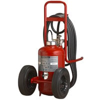 Back-facing red pressure transfer fire extinguisher on hand truck with long hose