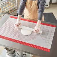 photo of a pastry chef rolling out dough