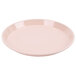 A light peach Cambro round tray with a white background.