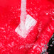 Water running over a red National Checking Company dissolvable product label.
