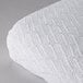 A white Oxford 100% cotton thermal herringbone hotel blanket on a white surface.