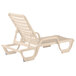 A tan resin chaise lounge chair.