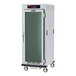 A white cabinet with glass doors on wheels.
