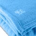 A light blue Oxford fleece blanket with a white bird design.