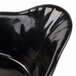 A black Tablecraft oval au gratin dish with a curved edge.