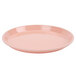 A dark peach Cambro round fiberglass tray with a small rim.