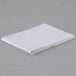A folded white Oxford T200 Superblend pillow case on a gray surface.
