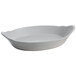 A white Tablecraft oval au gratin dish with a handle.