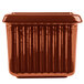 A brown rectangular cast aluminum server with ridges.