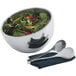A Vollrath double wall metal bowl of salad with tongs.