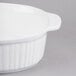 A white Tablecraft oval casserole dish with ridges and a lid.