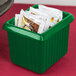 A Tablecraft green cast aluminum rectangle server with packets in it.