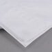A white Oxford T300 Super Deluxe pillow case unfolded on a gray surface.
