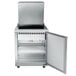 A stainless steel Traulsen refrigerated sandwich prep table with a door open.