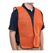 A man wearing a Cordova orange high visibility mesh safety vest over a black shirt.