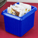 A Tablecraft cobalt blue cast aluminum rectangle server with ridges holding packets on a hotel buffet counter.