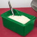 A Tablecraft green rectangular server with ridges filled with white rice and a spoon.