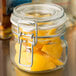 A Libbey Garden Jar filled with lemons on a counter.