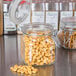 A close-up of a Libbey Garden Jar filled with peanuts on a counter.