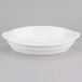 A white Tablecraft cast aluminum oval casserole dish with handles.