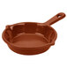 A brown cast aluminum fry pan with a handle.