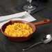 A bowl of macaroni and cheese served in a Tablecraft copper fry pan.