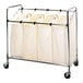 A chrome laundry cart with four white canvas bags.