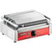 An Avantco stainless steel commercial panini grill with a red and black handle.