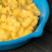 A sky blue Tablecraft fry pan filled with macaroni and cheese.