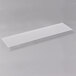 A white rectangular object with a clear plastic strip.