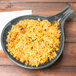 A Tablecraft gray cast aluminum skillet filled with rice and beans.