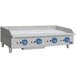 A large stainless steel Globe gas griddle on a countertop with blue knobs.