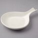 A white Tuxton China fry pan server with a handle.