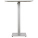 A white square table with a metal pedestal.