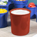 A Tablecraft copper salad dressing bowl with white liquid in it next to blue and yellow food containers.