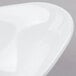 A close up of a white Tablecraft Frostone melamine bowl with a curved edge.