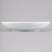 A white Tablecraft cast aluminum pasta bowl on a gray surface.