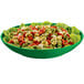 A Tablecraft green cast aluminum pasta bowl filled with tortellini and lettuce.