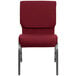 A Flash Furniture burgundy church chair with silver metal legs.