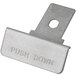A close-up of a white push-down plate with the words "push down" on it.