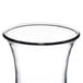 A clear plastic hurricane glass with a black rim.