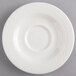 A Homer Laughlin Kensington Ameriwhite saucer with a circular pattern on the edge.