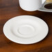 A Homer Laughlin Kensington Ameriwhite bright white saucer on a table.