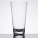 A Thunder Group plastic mixing glass on a table.