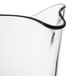 A clear polycarbonate pitcher with a curved handle.