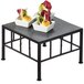 A black Cal-Mil square riser with slate top holding food on a table.